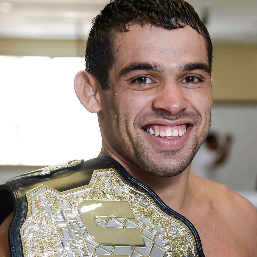 Champion MMA fighter smiling with championship belt over shoulder — Renan Barão Wallpaper