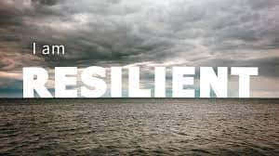 Ocean under storm clouds with text saying I am RESILIENT — Resilient Wallpaper