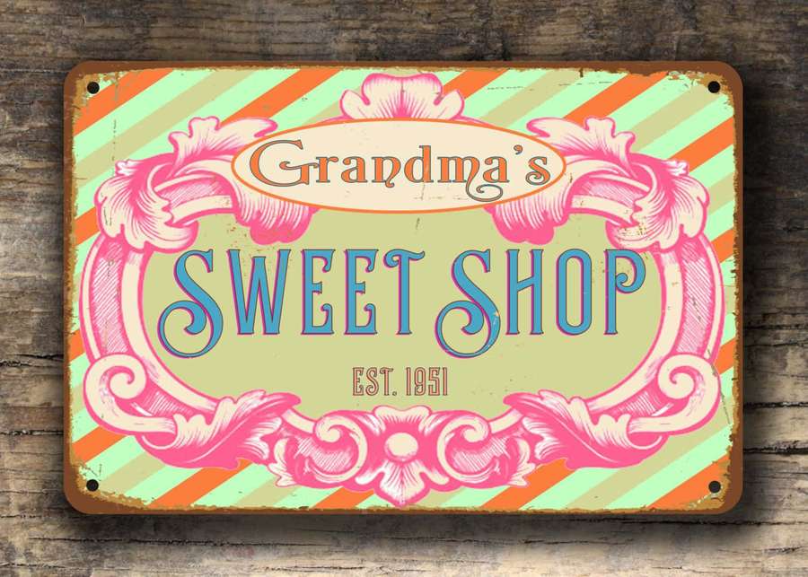 Retro sweet shop sign with pink swirls and striped background on wooden wall. — Retro Candy Aesthetic Wallpaper