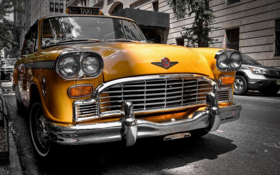 Vintage yellow taxi parked on city street with chrome details. — Retro Car Wallpaper