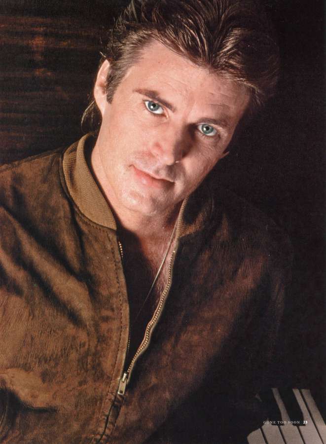 Close-up portrait of a man with blue eyes in a brown suede jacket. — Rick Nelson Wallpaper