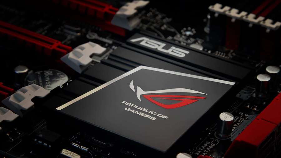 Close-up of ASUS ROG gaming motherboard with red and black components. — Rog Background