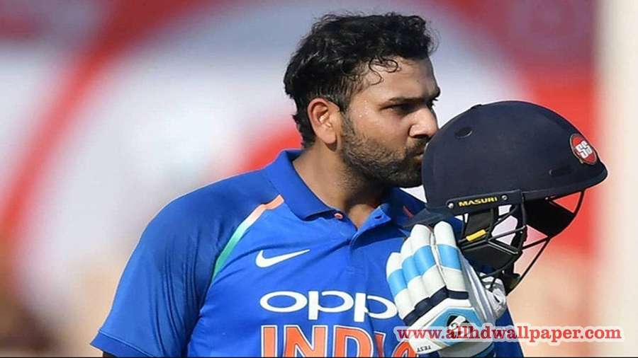 Indian cricket player holding helmet and gloves during match — Rohit Wallpaper