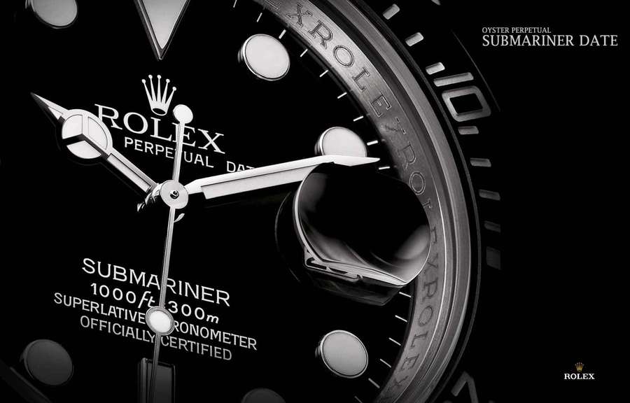 Close-up of a Rolex Submariner watch face with silver hands and text on black dial. — Rolex Background