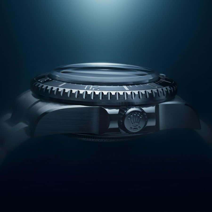 Close-up of a luxury watch crown and bezel under dramatic lighting. — Rolex HD Background