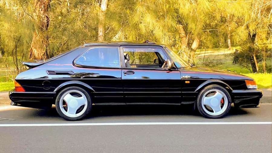 Black Saab 900 Turbo parked on roadside with trees in golden light. — Saab 99 Wallpaper