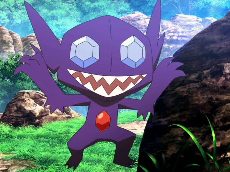 Purple cartoon monster with gem eyes and red chest standing in grassy forest. — Sableye Wallpaper