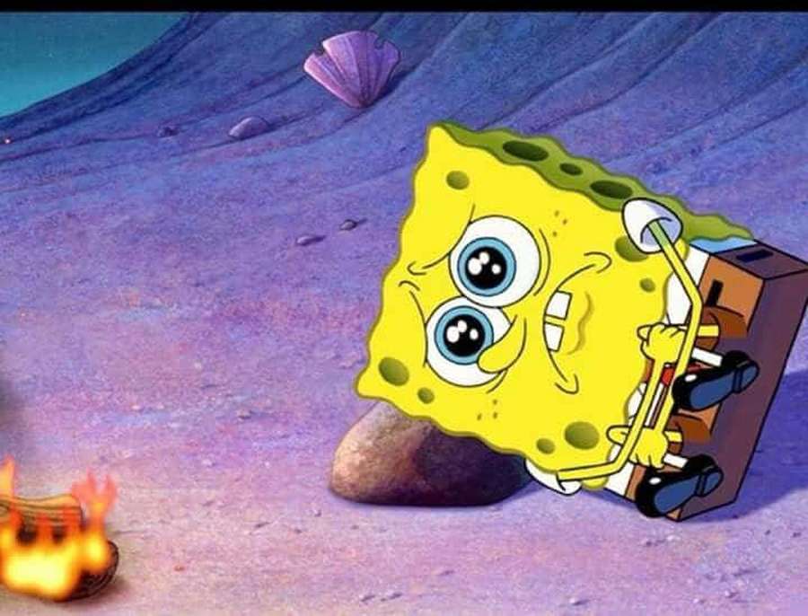 SpongeBob SquarePants looks sad while sitting by a campfire underwater. — Sad Spongebob Wallpaper