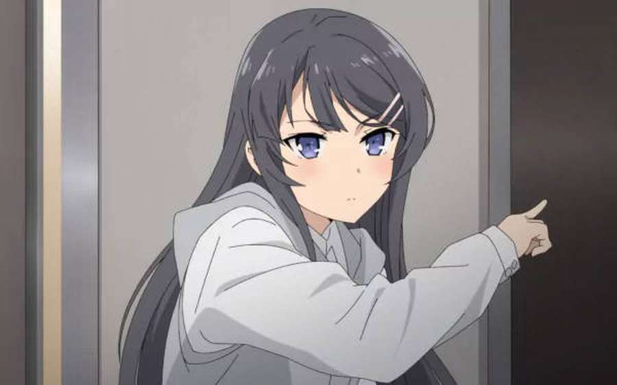 Anime girl with dark hair and blue eyes pointing forward in a hallway. — Sakurajima Wallpaper