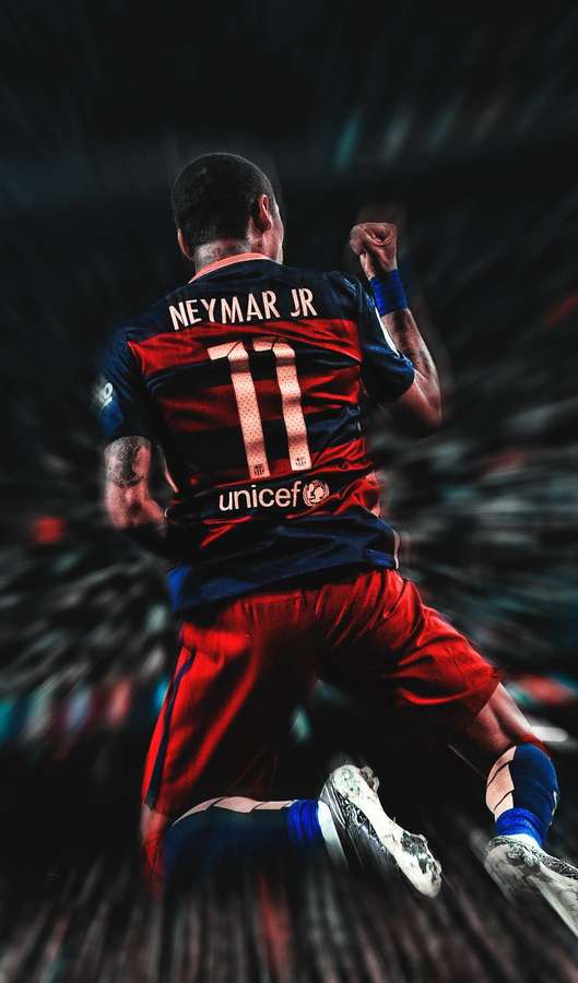 El futbolista Neymar Jr. celebra la victoria con el puño en alto en el estadio. — Saltando Fondos de pantalla