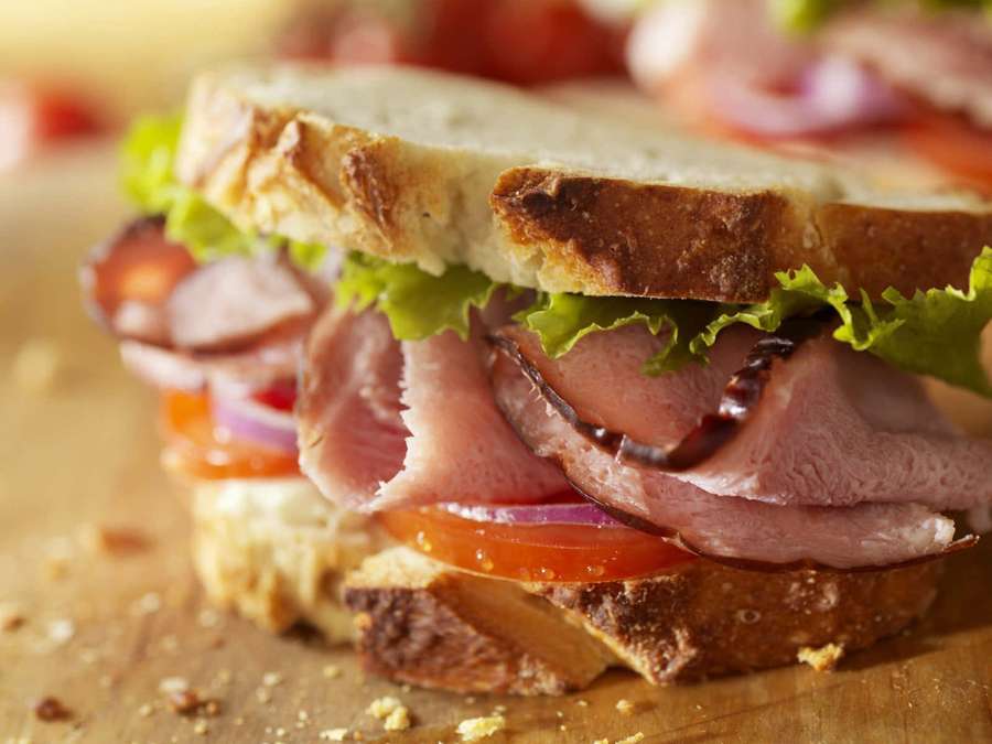 A delicious ham and tomato sandwich on toasted bread on a wooden board. — Sandwich Background