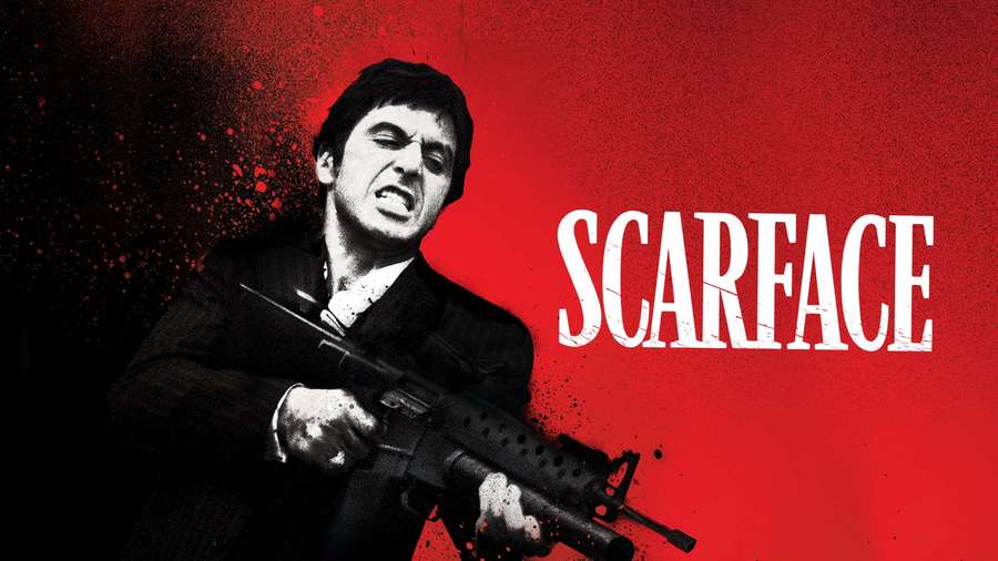 A man in a suit holding a rifle with a red splatter background and the word SCARFACE. — Scarface Background