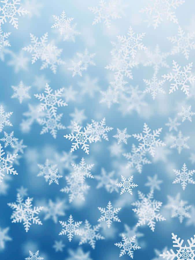 Schneeflocken fallen in einem kühlen blauen Himmel — Schneeflocken hintergrundbilder Hintergrundbild