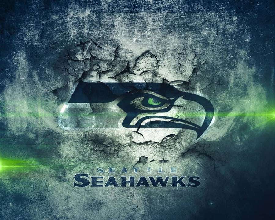 Seattle Seahawks logo breaking through cracked concrete with green light effects. — Seahawks Background