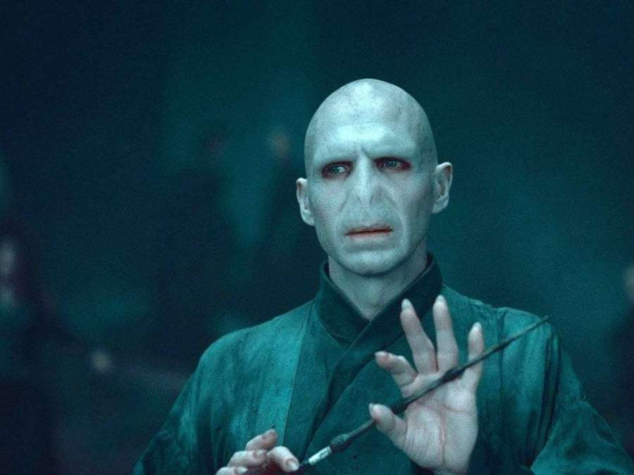 Voldemort segurando uma varinha em um ambiente teal escuro. — Senhor Voldemort Papéis de Parede