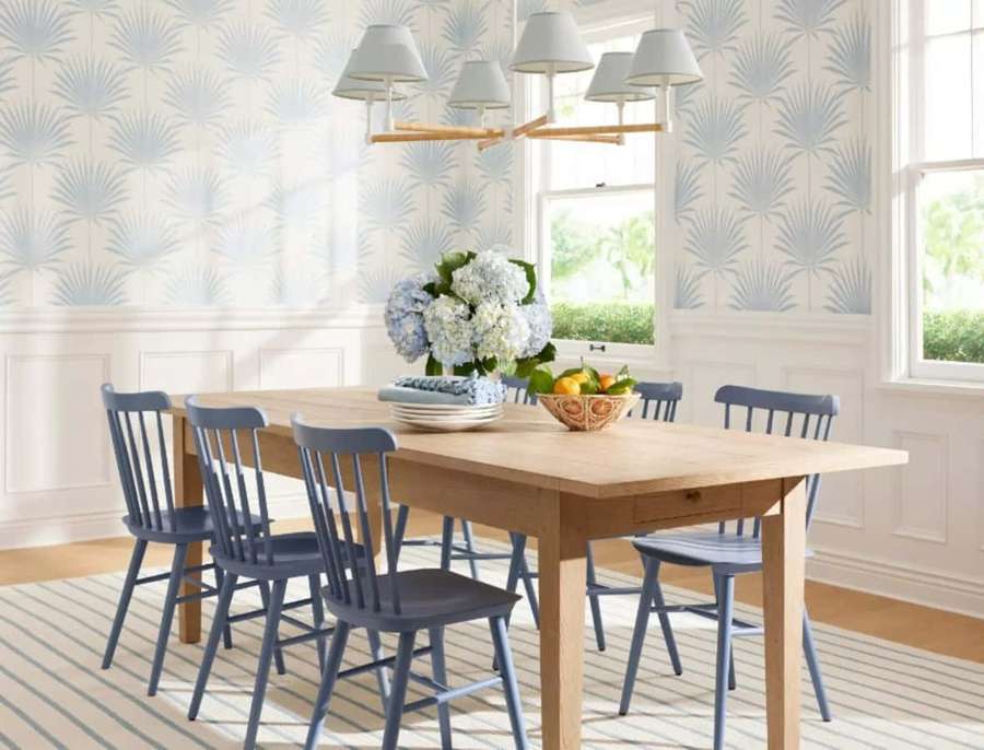 Dining room with wooden table blue chairs and palm leaf wallpaper. — Serena And Lily Wallpaper