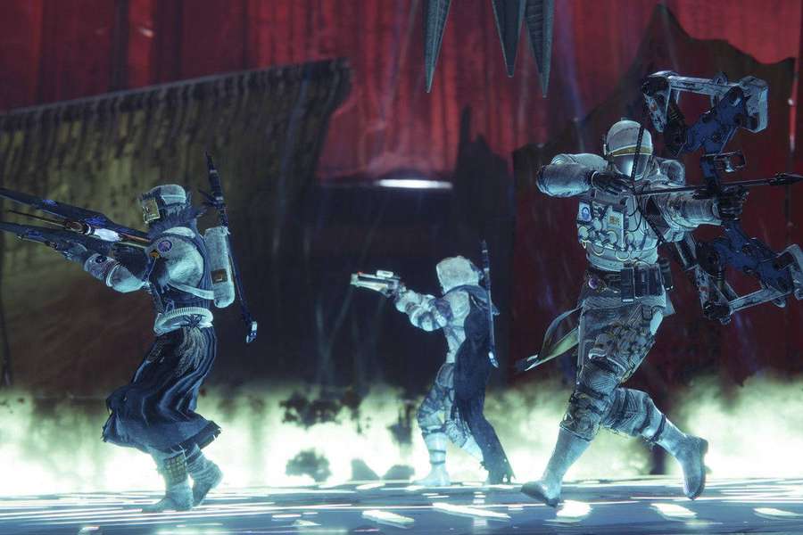 Three futuristic soldiers firing weapons in a red-lit industrial combat zone. — Shadowkeep Picture