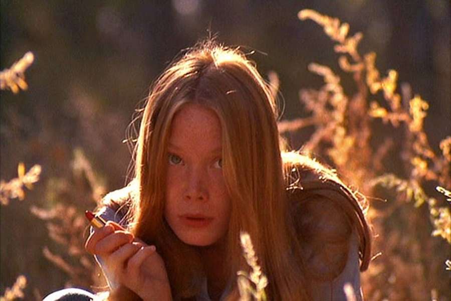 Junges Mädchen mit roten Haaren, das durch goldenes Gras im warmen Sonnenlicht lugt. — Sissy Spacek Wallpaper