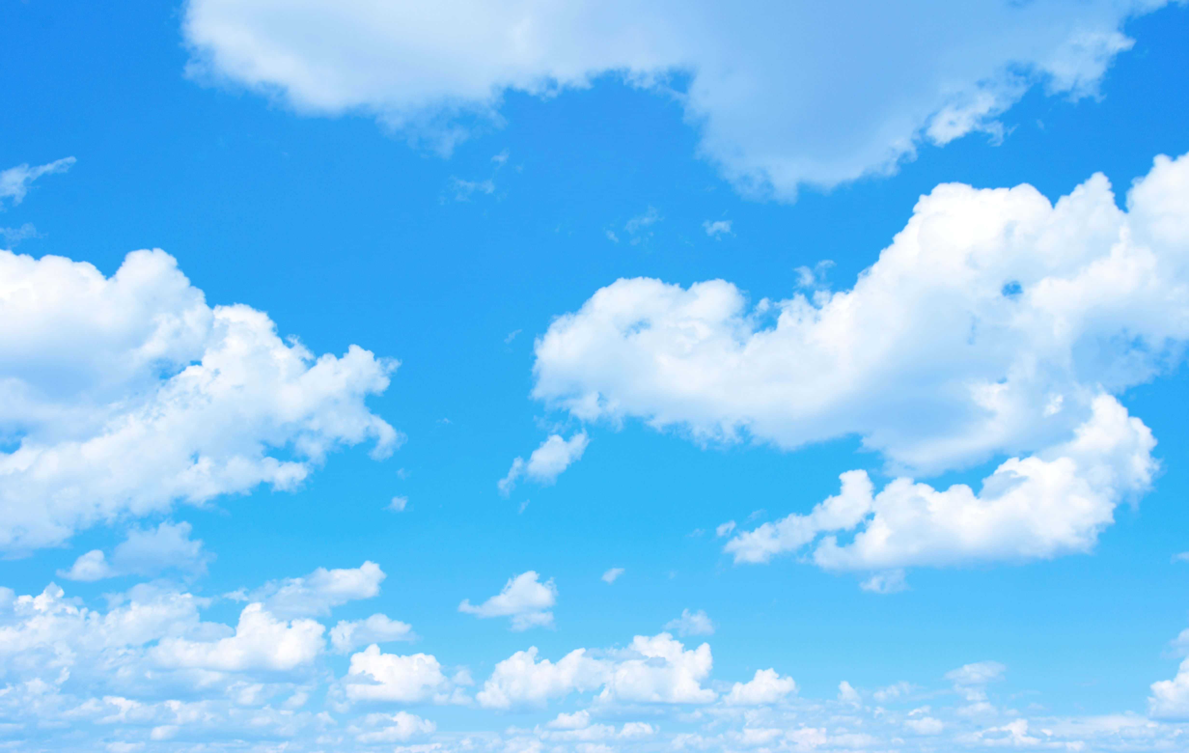 Bright blue sky with scattered fluffy white clouds — Sky Wallpaper