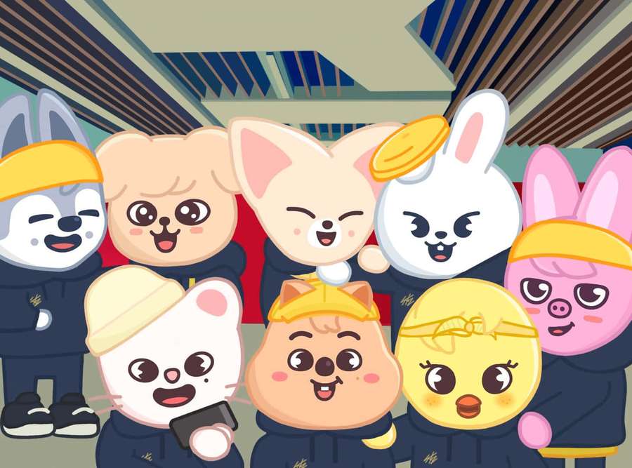 A group of smiling cartoon animals in matching uniforms posing indoors. — Skzoo Wallpaper