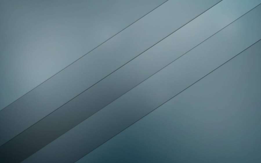 Abstract geometric pattern of diagonal gray metallic stripes with soft gradient lighting. — Sleek Background