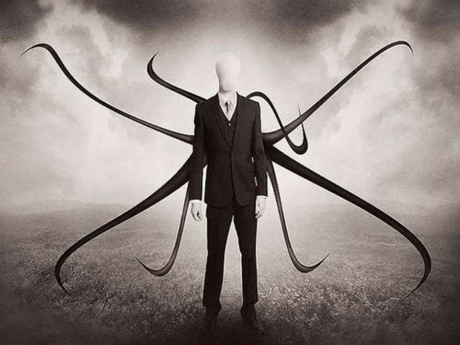 Gesichtsloser humanoider mit Tentakeln auf einem stürmischen Feld in einem Anzug. — Slender Man Bilder