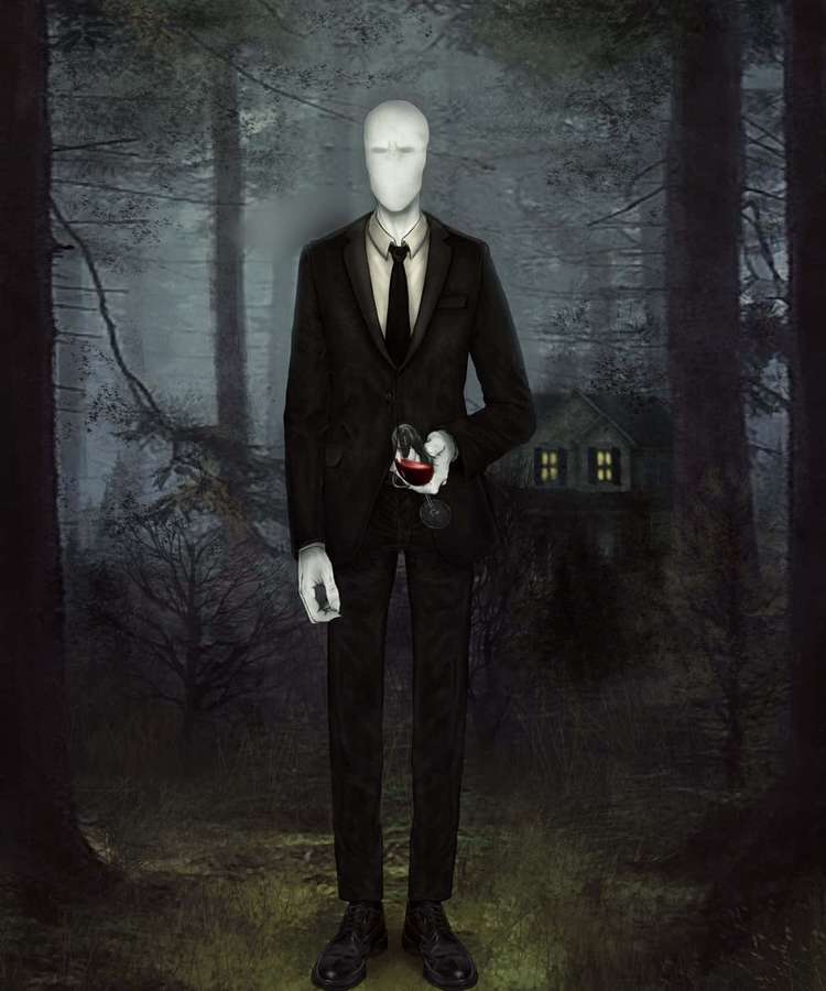 Faceless man in black suit holding wine glass in eerie forest with lit house. — Slender Man Picture