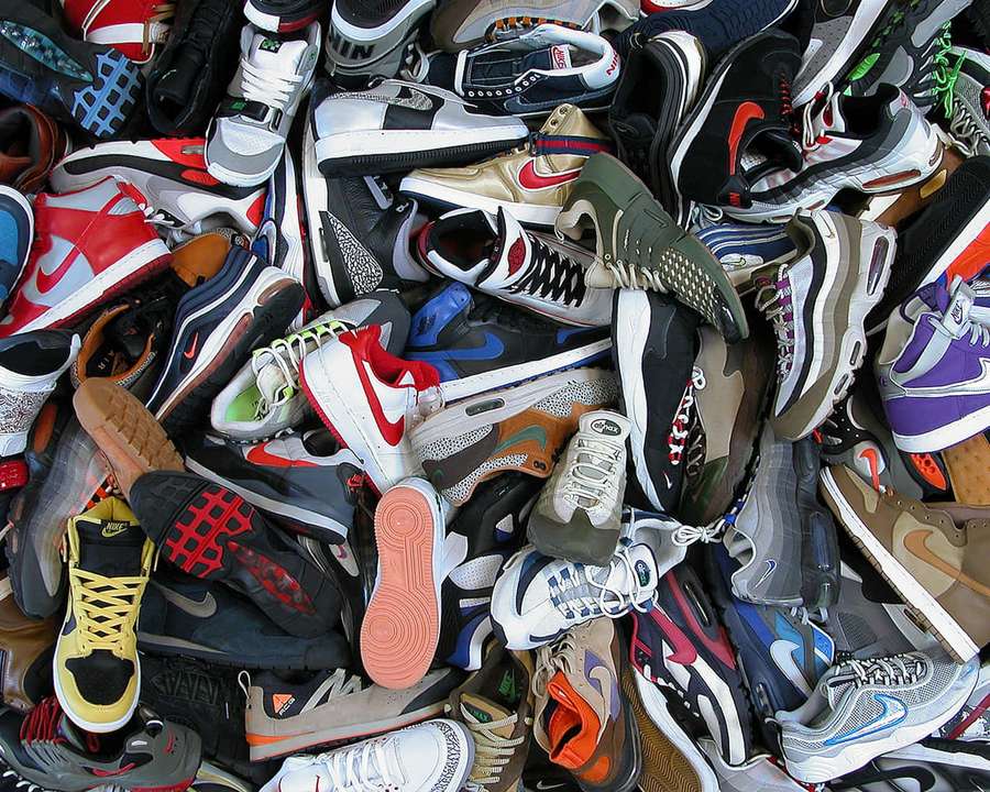 A large pile of assorted sneakers in various colors and styles. — Sneaker Background