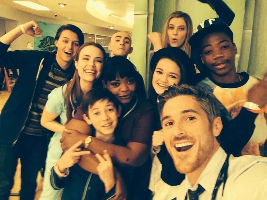 A group of young actors smiling and posing together indoors. — Society Background