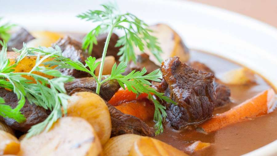 Rico estofado de ternera con zanahorias, champiñones y perejil en un bol blanco. — Sopa Fondos de pantalla
