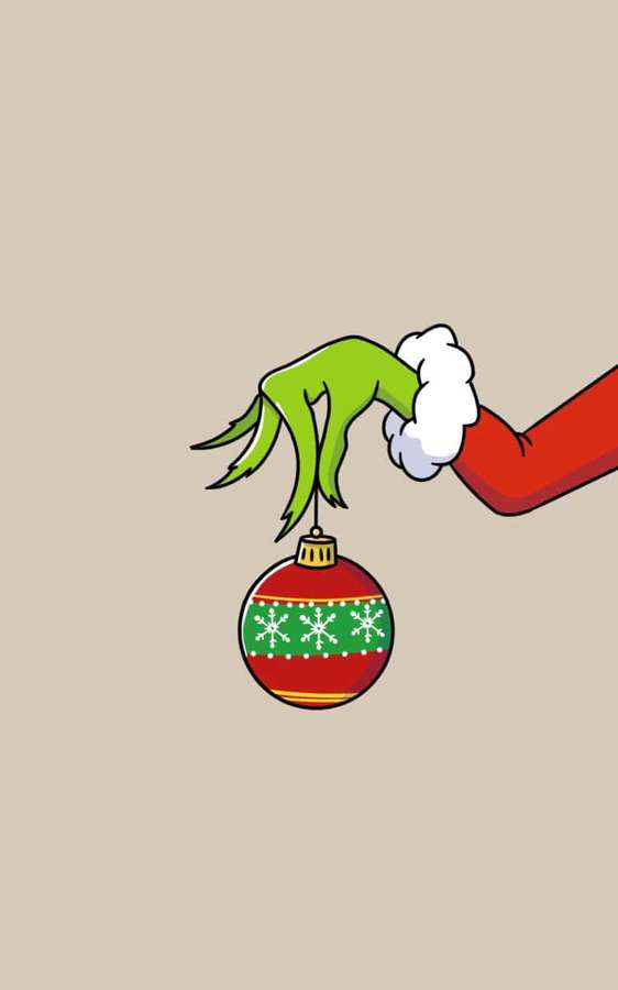 Grinch-käsi pitää juhlavaa joulukoristetta lumihiutaleilla. — Söpö Grinch Taustakuvat