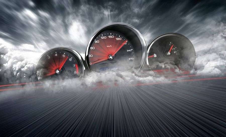 Three car gauges with red needles against a stormy sky and speeding road. — Speedtest Wallpaper