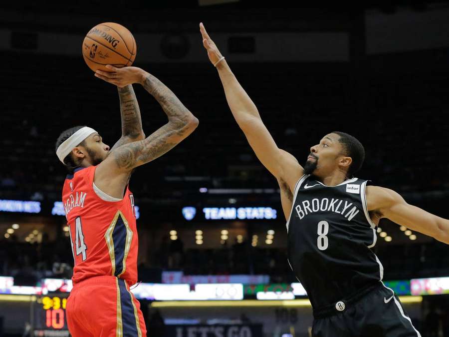 Basketball player shooting over defender during game — Spencer Wallpaper