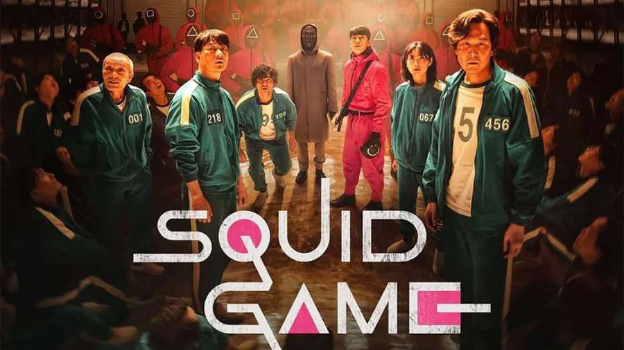 Squid Game contestants in numbered tracksuits stand in a tense game room with masked figures. — Squid Game Background