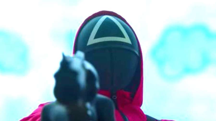 Person in red hood with white triangle aiming handgun — Squid Game Pfp Wallpaper