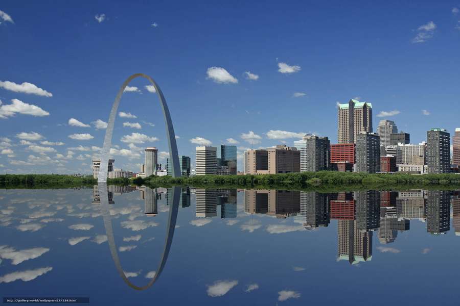 Gateway Arch y horizonte de la ciudad reflejados en un río tranquilo bajo un cielo azul. — St. Louis Fondos de pantalla