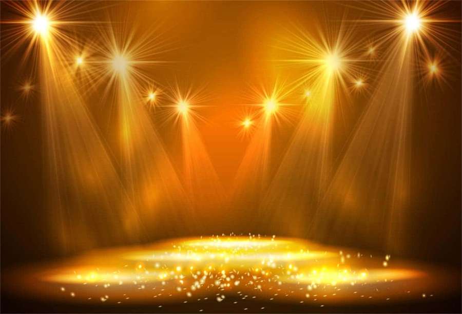 Golden stage lights illuminate a sparkling circular platform in a dark theater. — Stage Background