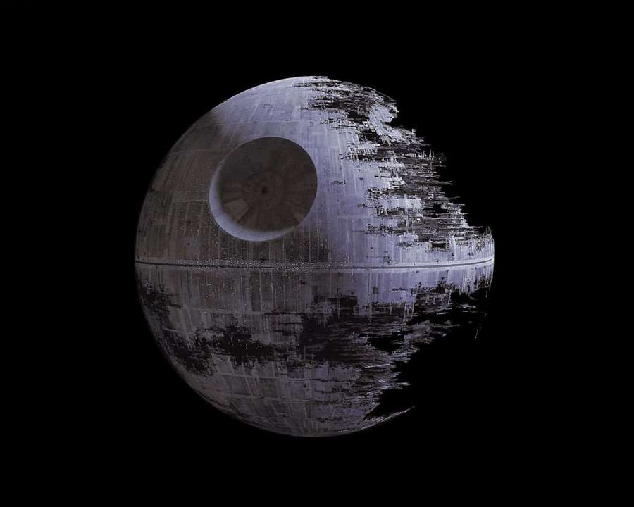 Damaged Death Star space station with battle scars against black space. — Star Background