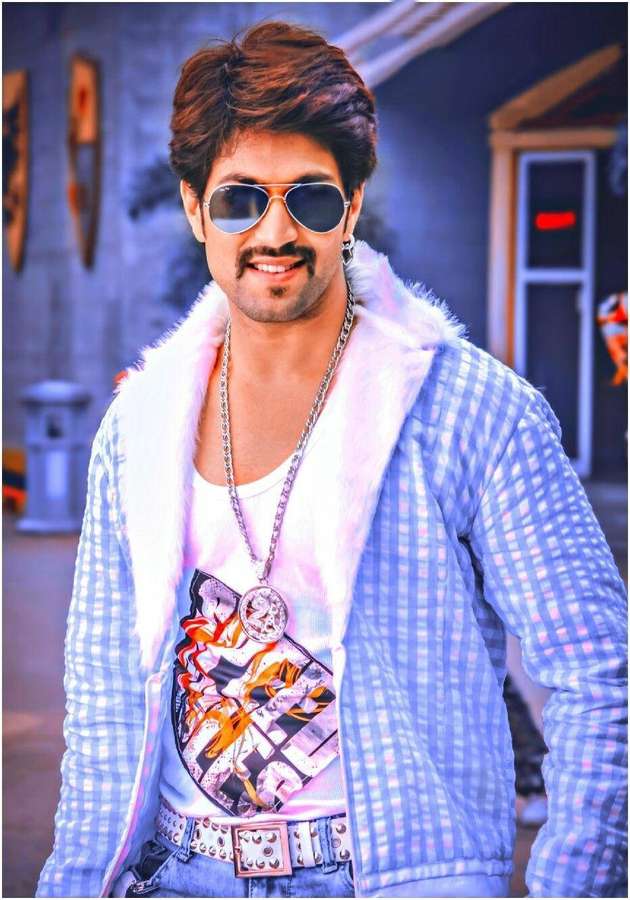 A stylish man wearing sunglasses and a checkered jacket smiles outdoors. — Stylish Boy Background