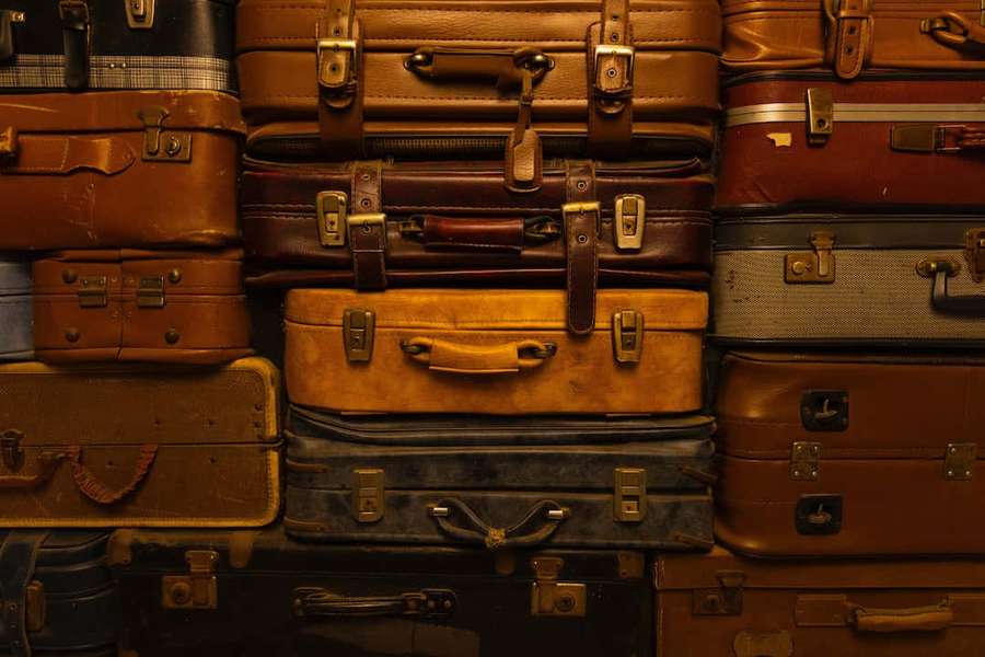 Stack of vintage leather suitcases in warm tones. — Suitcase Wallpaper
