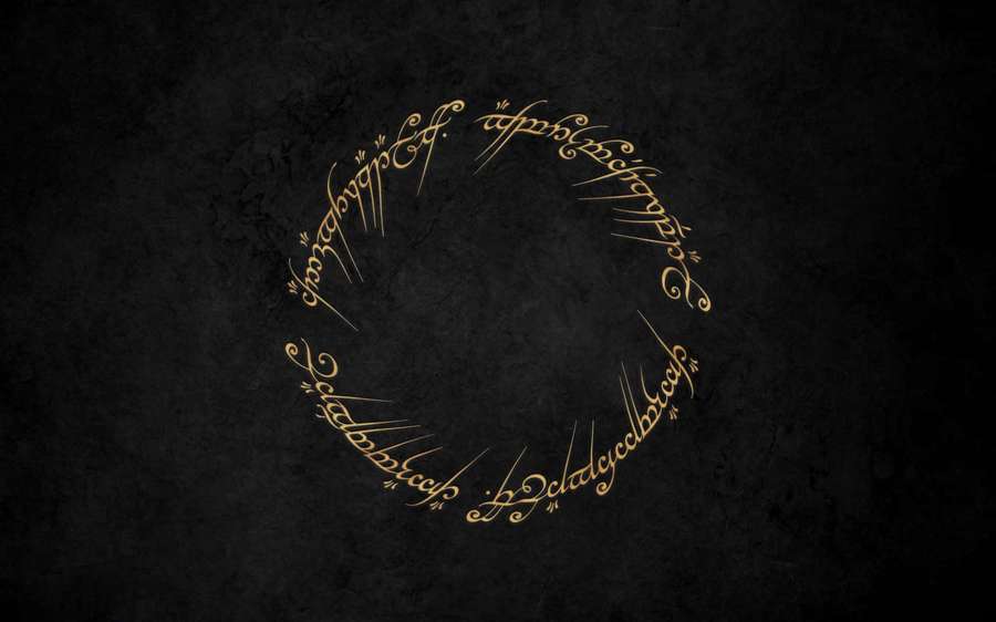 Leuchtende goldene Elbenschrift in einem Kreis auf dunklem, strukturiertem Hintergrund. — Super Mario Odyssee Wallpaper