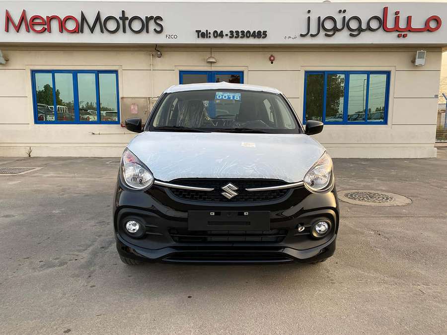 Silver Suzuki Swift car at Mena Motors dealership during daytime. — Suzuki Celerio Wallpaper
