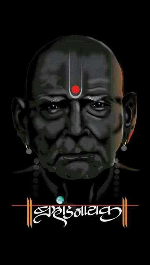 Serious ancient sage with red bindi and silver earrings against black background. — Swami Background