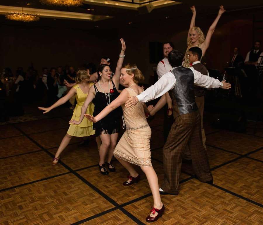 People dancing in 1920s style at a formal ballroom event. — Swing Dance Wallpaper