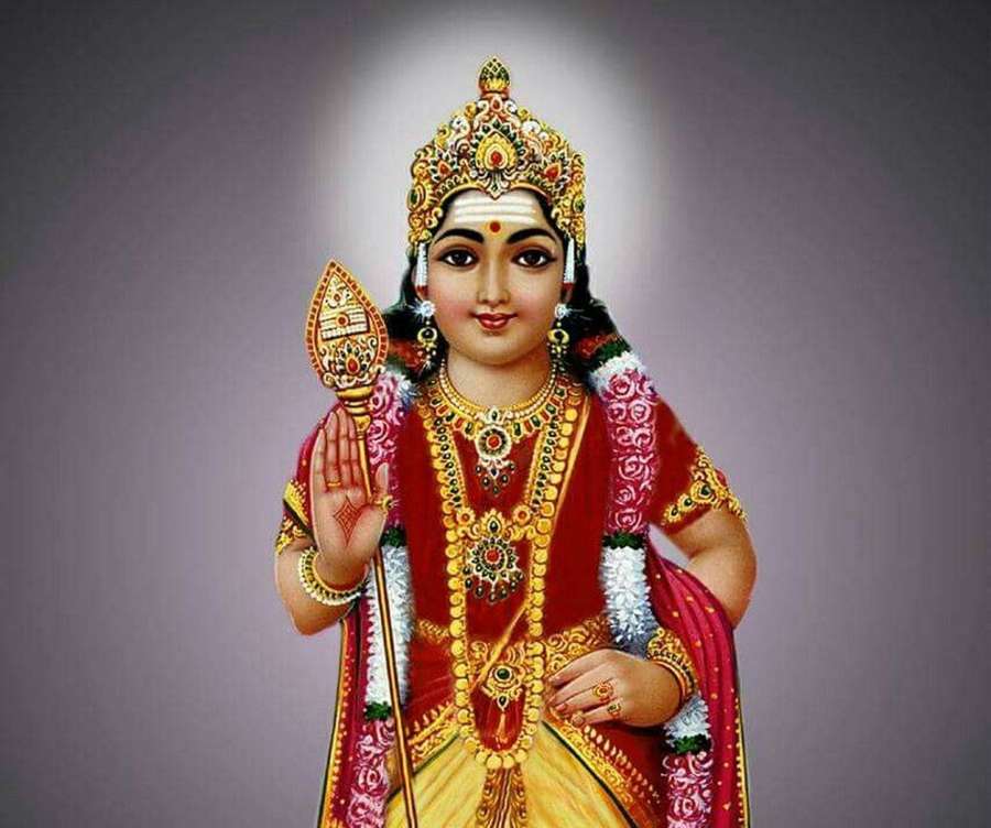 A Hindu goddess in ornate red and gold attire with jewelry and a halo. — Tamil God Wallpaper