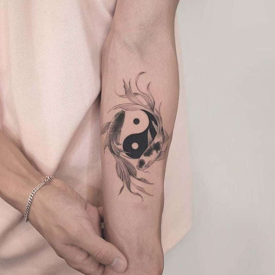 Black and white koi fish tattoo forming yin yang symbol on inner forearm. — Tattoos Picture