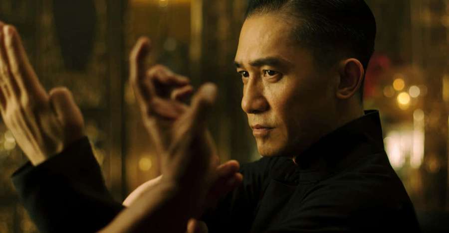 Man practicing martial arts in a dimly lit urban alley at night. — The grandmaster Wallpaper