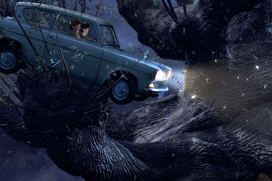 A giant bear crushes a vintage car with two people inside in a dark forest. — The Whomping Willow Wallpaper