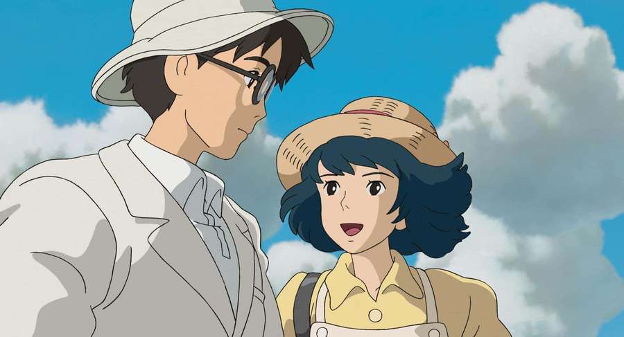 Two anime characters wearing hats look at each other under a blue sky with clouds. — The Wind Rises Wallpaper