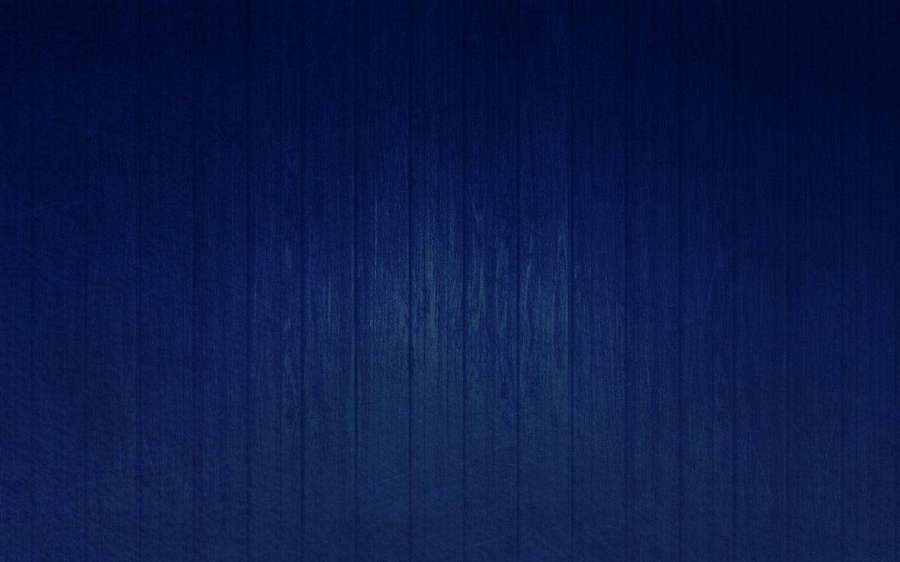 Dark blue wooden plank texture with vertical grain and soft gradient. — Thin Background